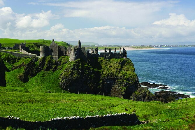 Giant's Causeway with the Titanic Exhibition and the best of Northern Ireland - Dunluce Castle stop: a dramatic coast view with quick timing